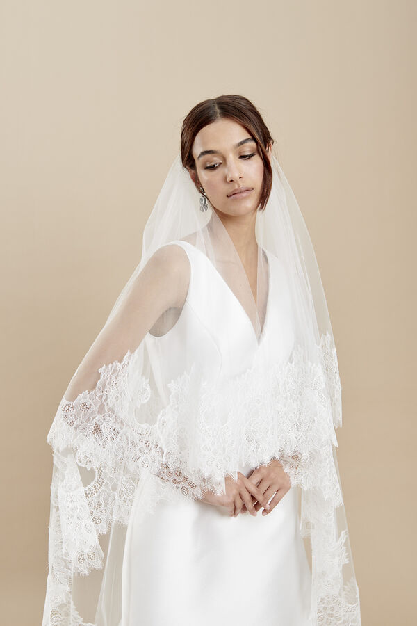 Two-tier tulle veil on a gathered comb with a Chantilly lace edge 